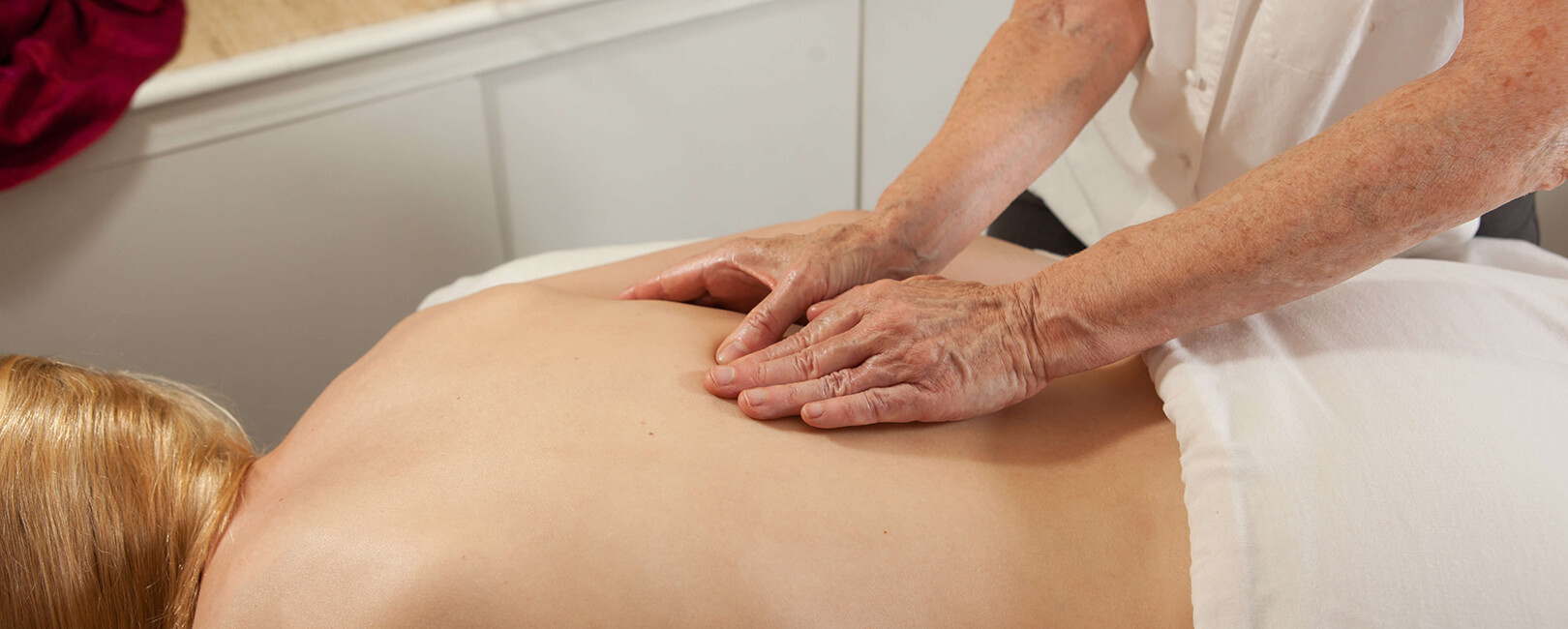 Renee Byrd, LMT's hands giving a massage to a woman during an appointment at Studio 210 Salon.